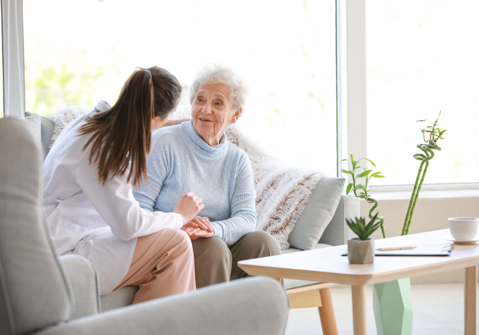 Doctor with senior woman in nursing home