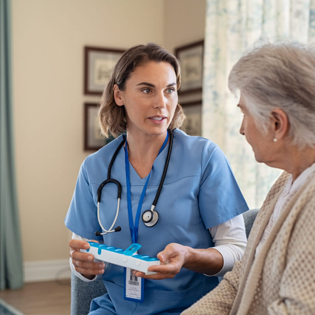 Nurse explaining medicine dosage to senior woman at nursing home